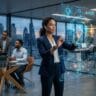 Human professional collaborating with AI technology in a futuristic workplace, showcasing creativity, emotional intelligence, and leadership skills in 2026